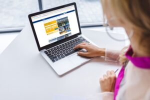 cropped view of woman using laptop with booking website