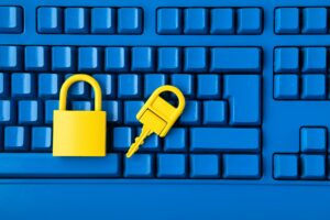 Cyber data and information security idea. Yellow padlock and key and blue keyboard. Computer