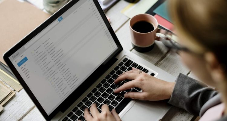 Businesswoman Checking E-mail Online on Laptop