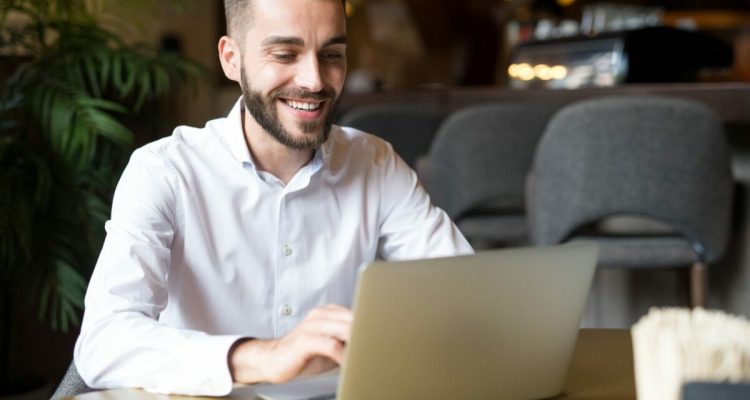 Cheerful Businessman Working in Cafe