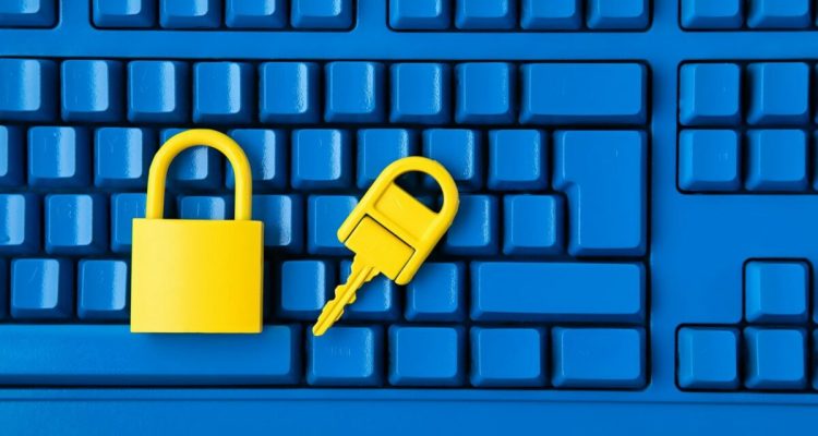 Cyber data and information security idea. Yellow padlock and key and blue keyboard. Computer