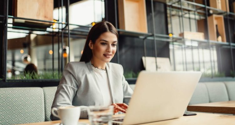 Young businesswoman using laptop.